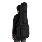 The man backpacks the black ACME acoustic guitar bag