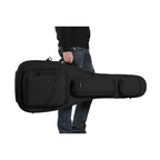 The man handles a black ACME acoustic guitar bag